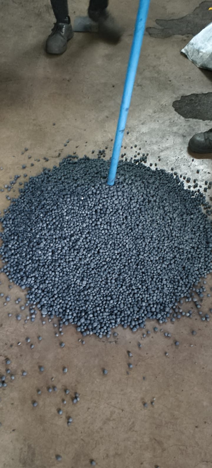 Sponge iron pellets being sampled