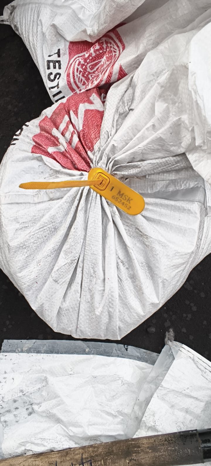 Tamper-sealed and numbered sample bag retained for reference