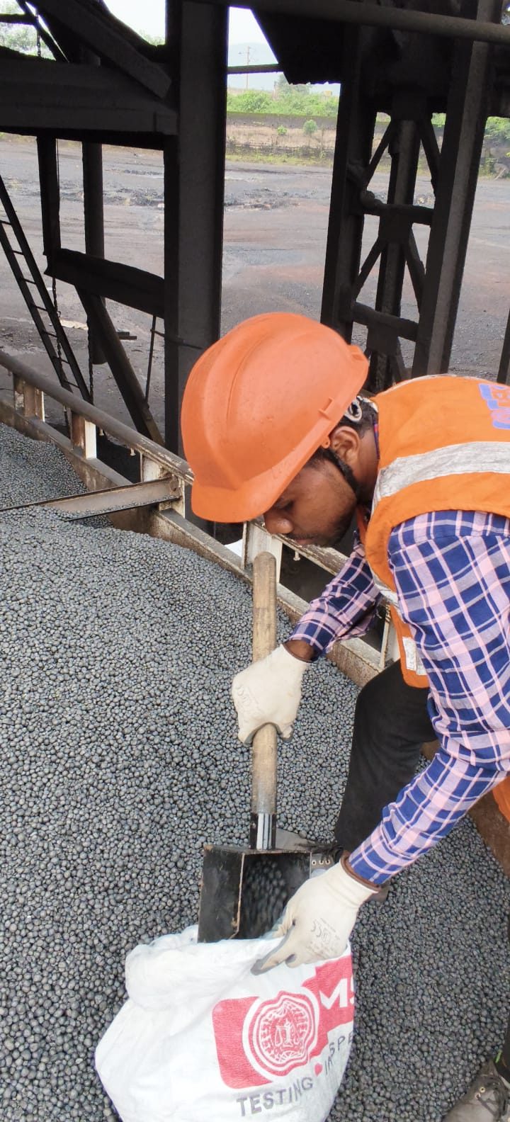 Independent inspector drawing a sample from the truck during loading